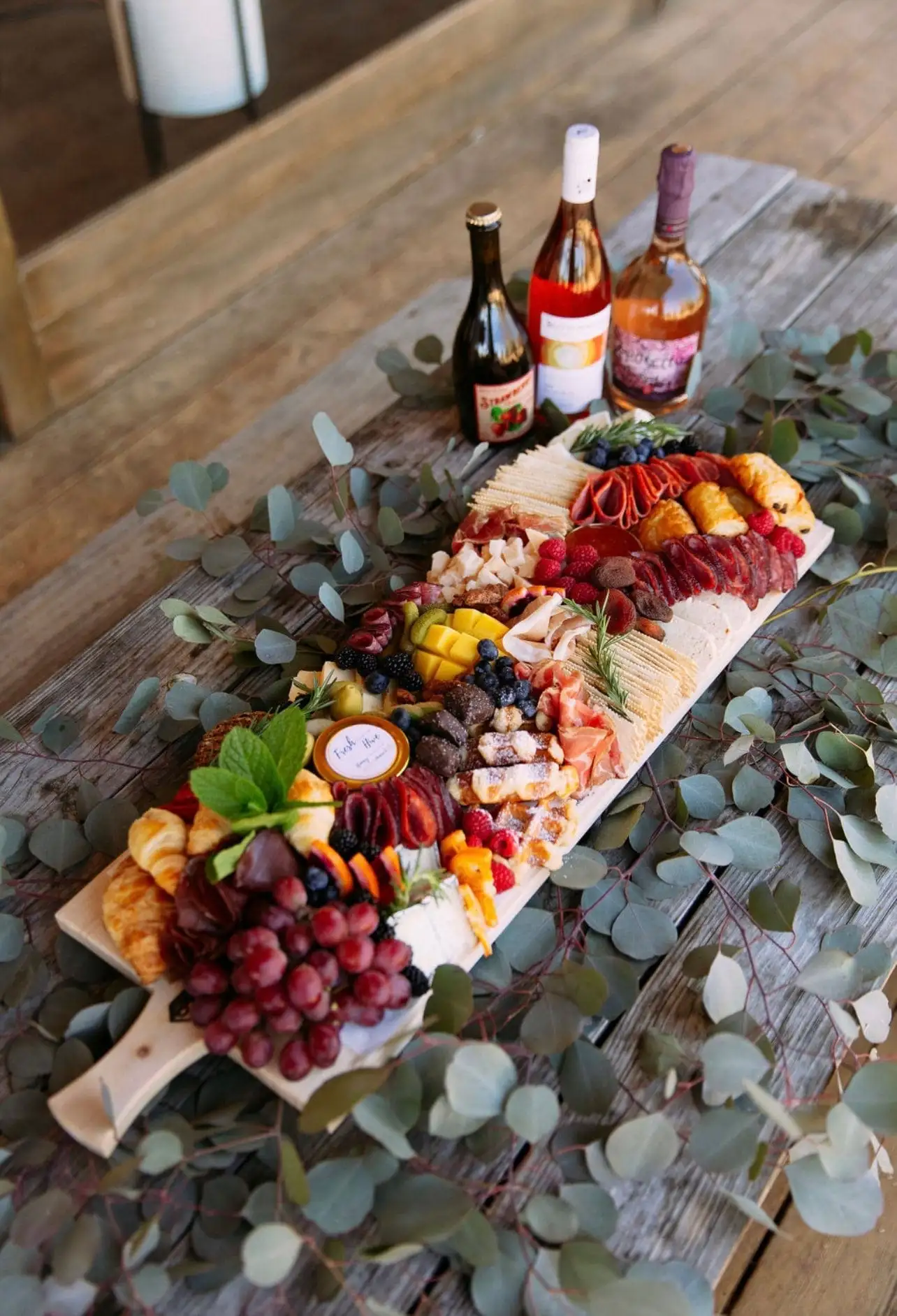 Brunch grazing board with croissants, waffles, cheeses, cured meats and fruit (view 6)