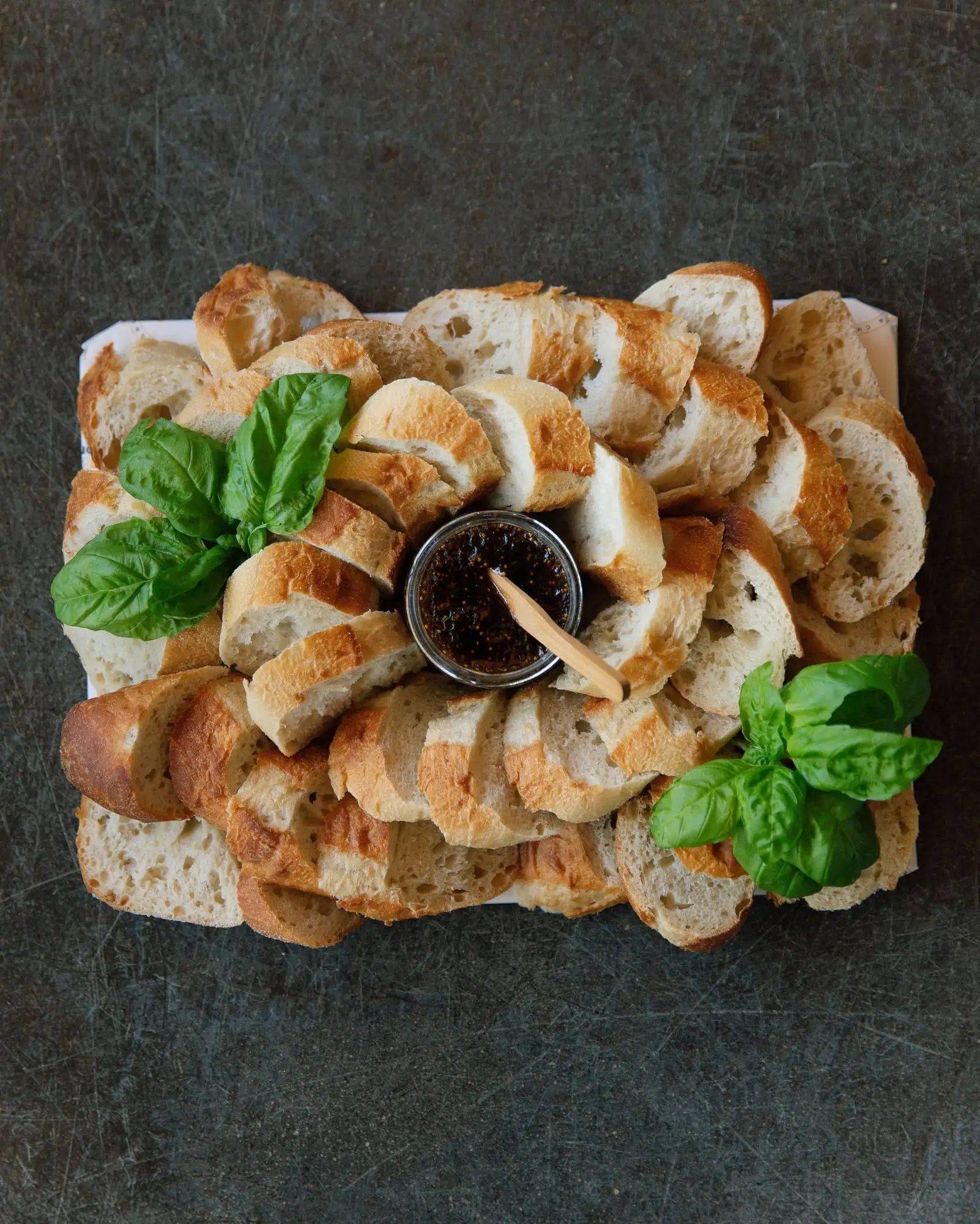 Sliced French baguette with fig spread, pepper jelly and honey (view 4)