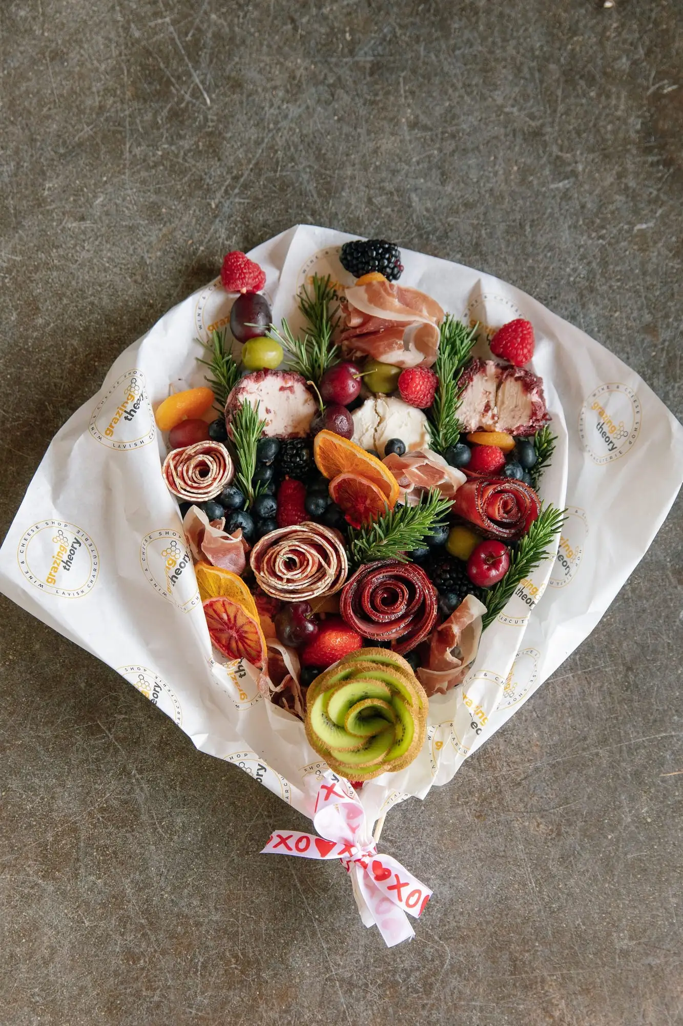 Edible bouquet of salami roses, cheese and fruit flowers