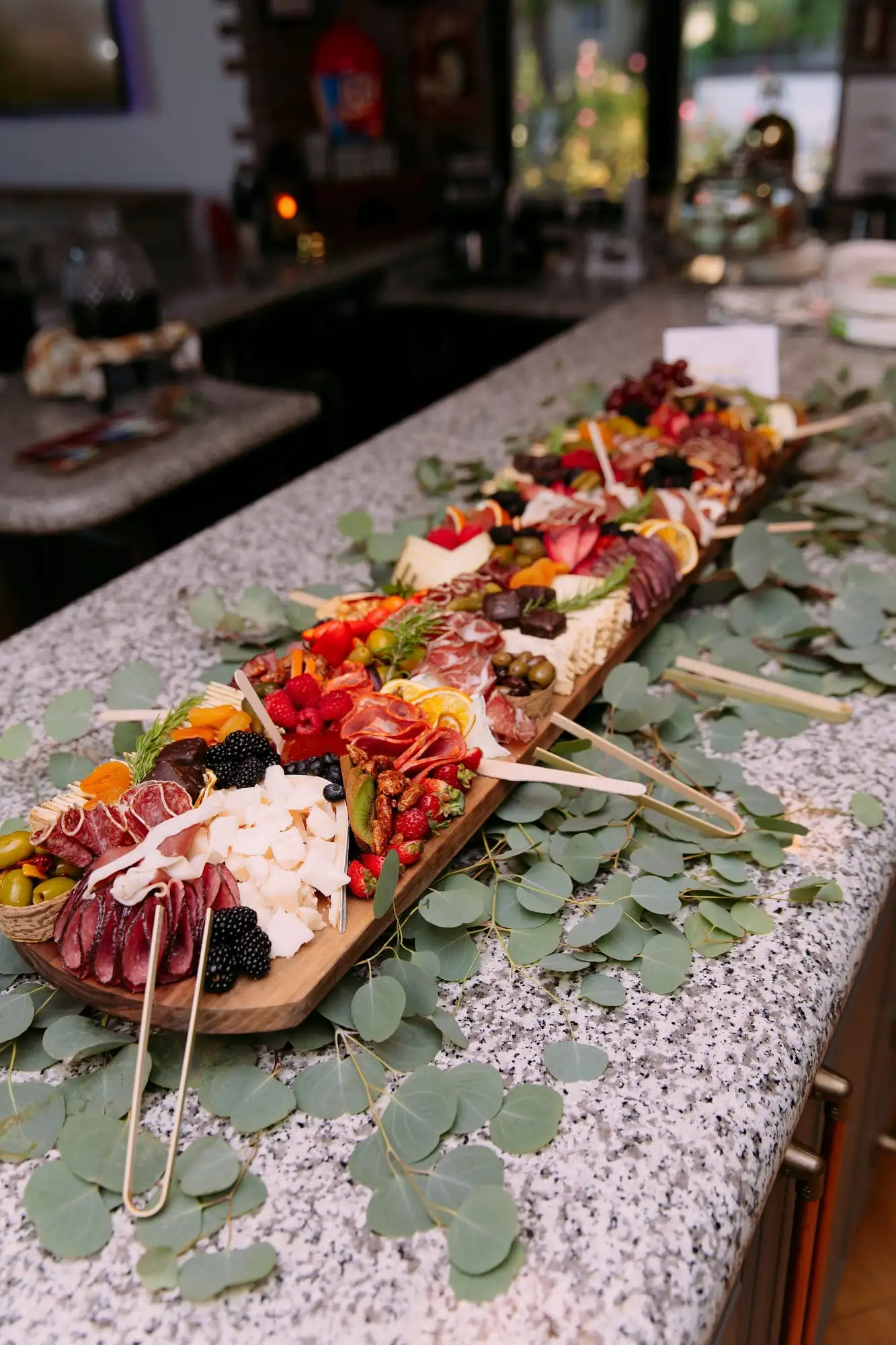Long charcuterie board with cheeses, cured meats, fruit and chocolates for 30 guests (view 7)