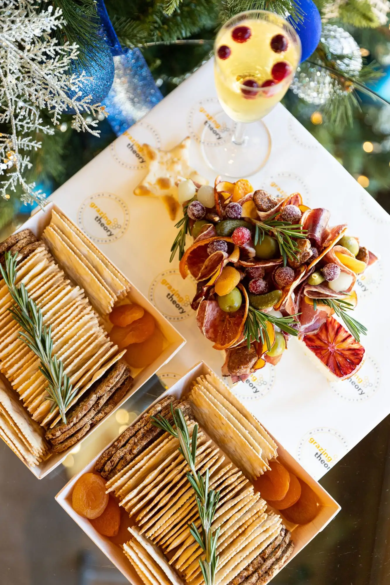 Brie cut into a Christmas tree shape and topped with cured meats and garnishes (view 3)