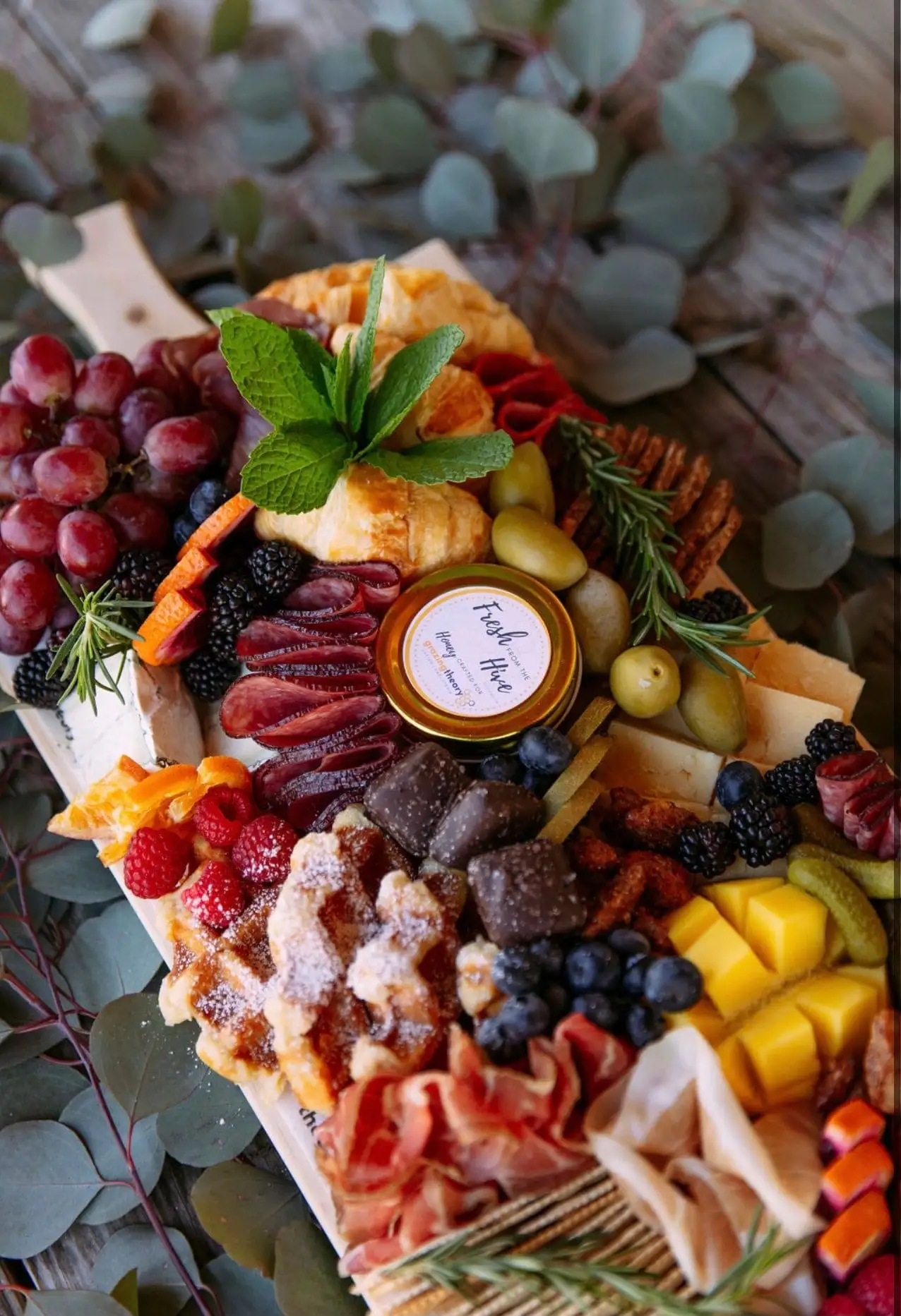 Brunch grazing board with croissants, waffles, cheeses, cured meats and fruit (view 5)