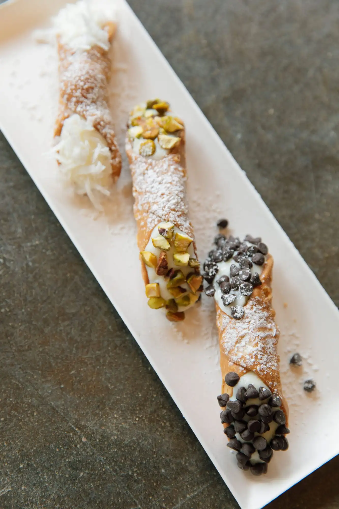 Ricotta-filled cannoli dusted with powdered sugar