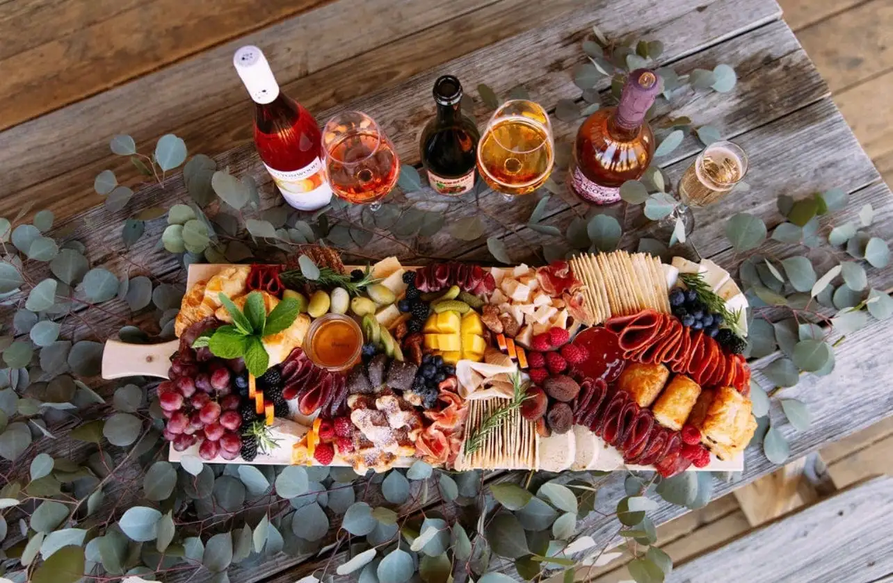Brunch grazing board with croissants, waffles, cheeses, cured meats and fruit (view 2)
