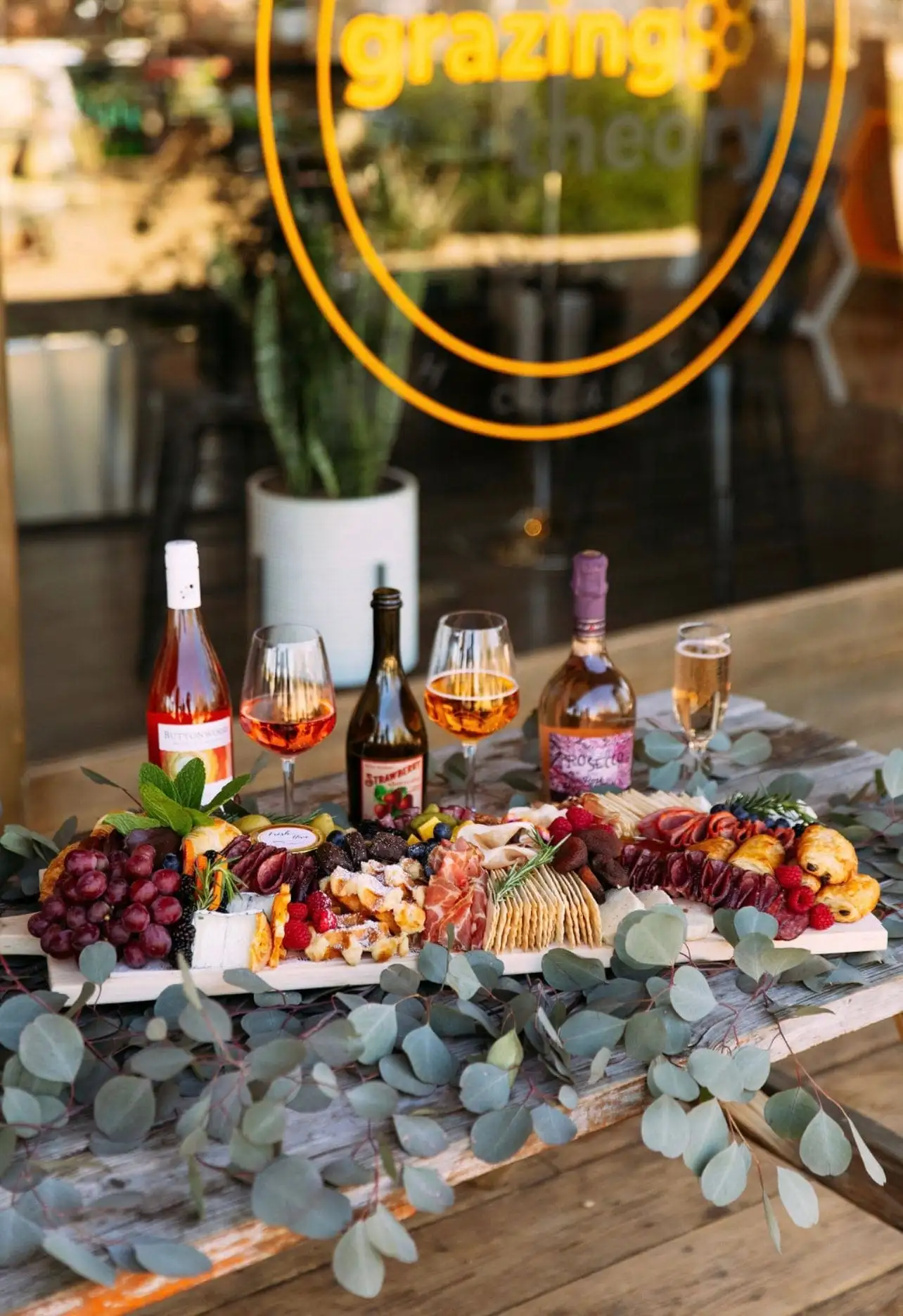 Brunch grazing board with croissants, waffles, cheeses, cured meats and fruit (view 3)
