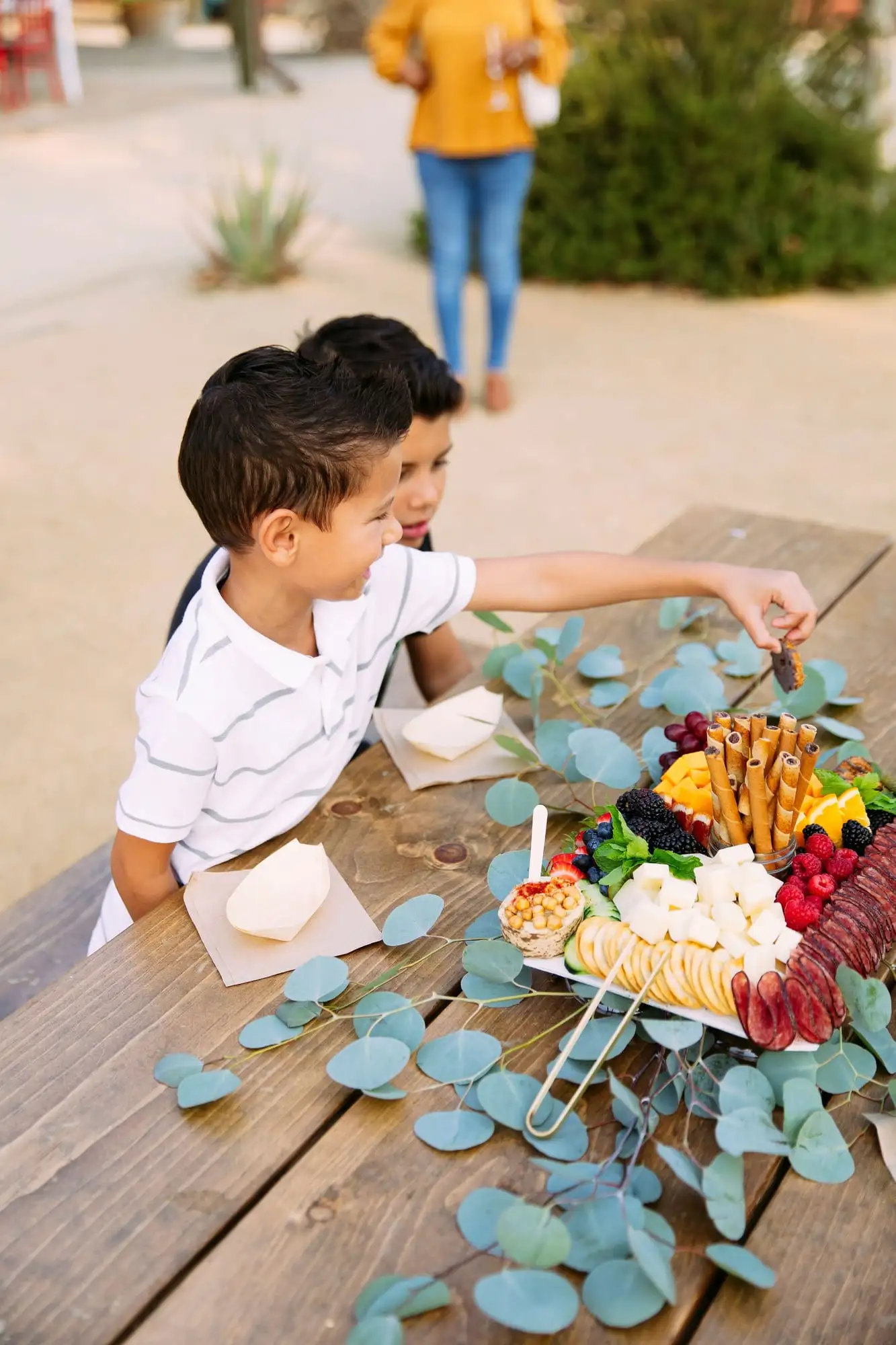 Kids grazing board with cheese sticks, fruit, cookies and crackers (view 3)