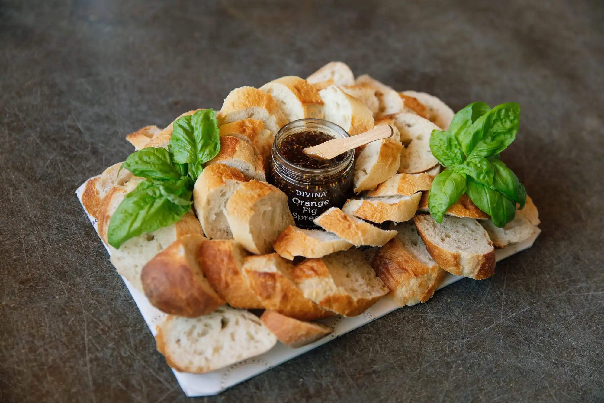 Sliced French baguette with fig spread, pepper jelly and honey (view 2)