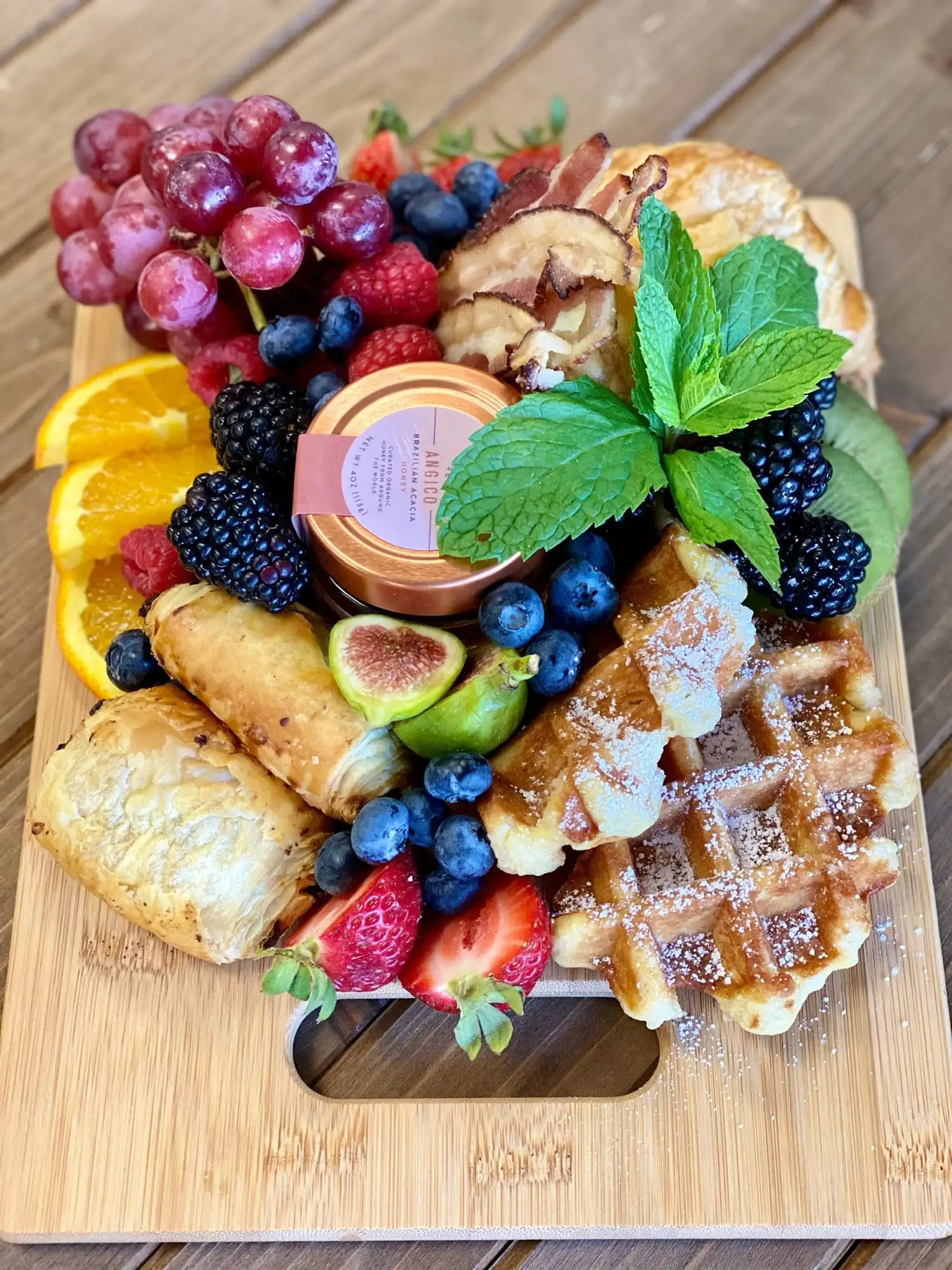 Small bamboo brunch board with croissants, waffles and fruit (view 2)
