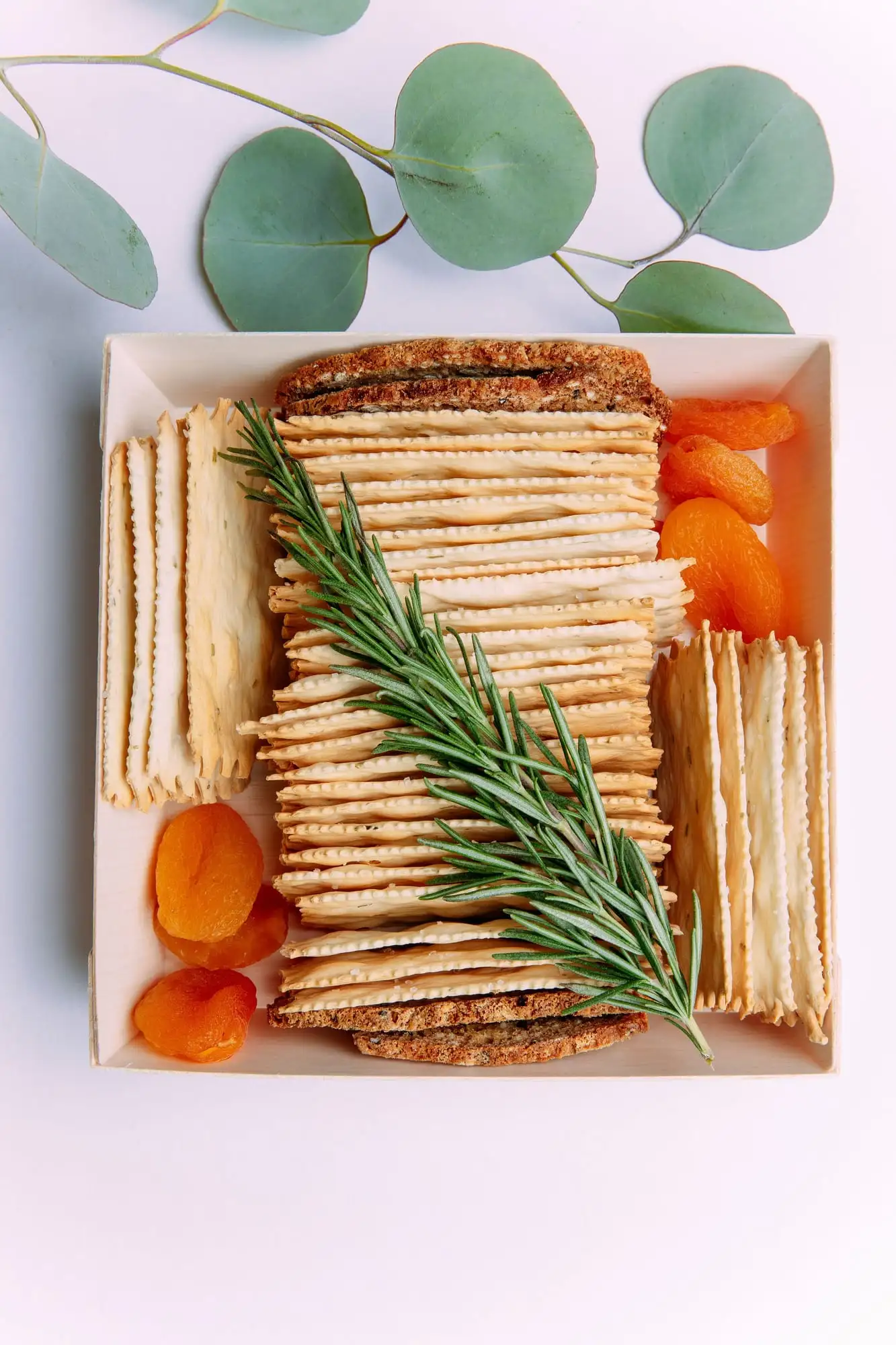 Brie cheese shaped into a number, topped with cured meat, fruit and herbs (view 4)