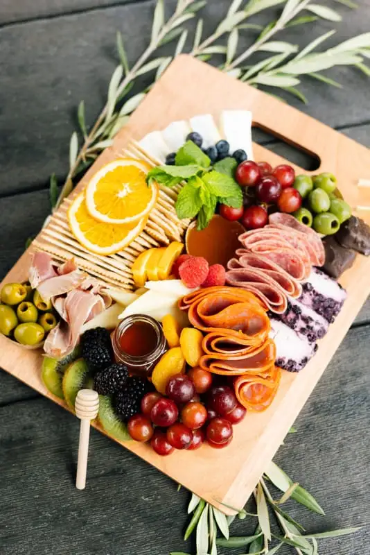Bamboo board with three cheeses, cured meats, fruit and crackers for 4 to 6 people (view 7)