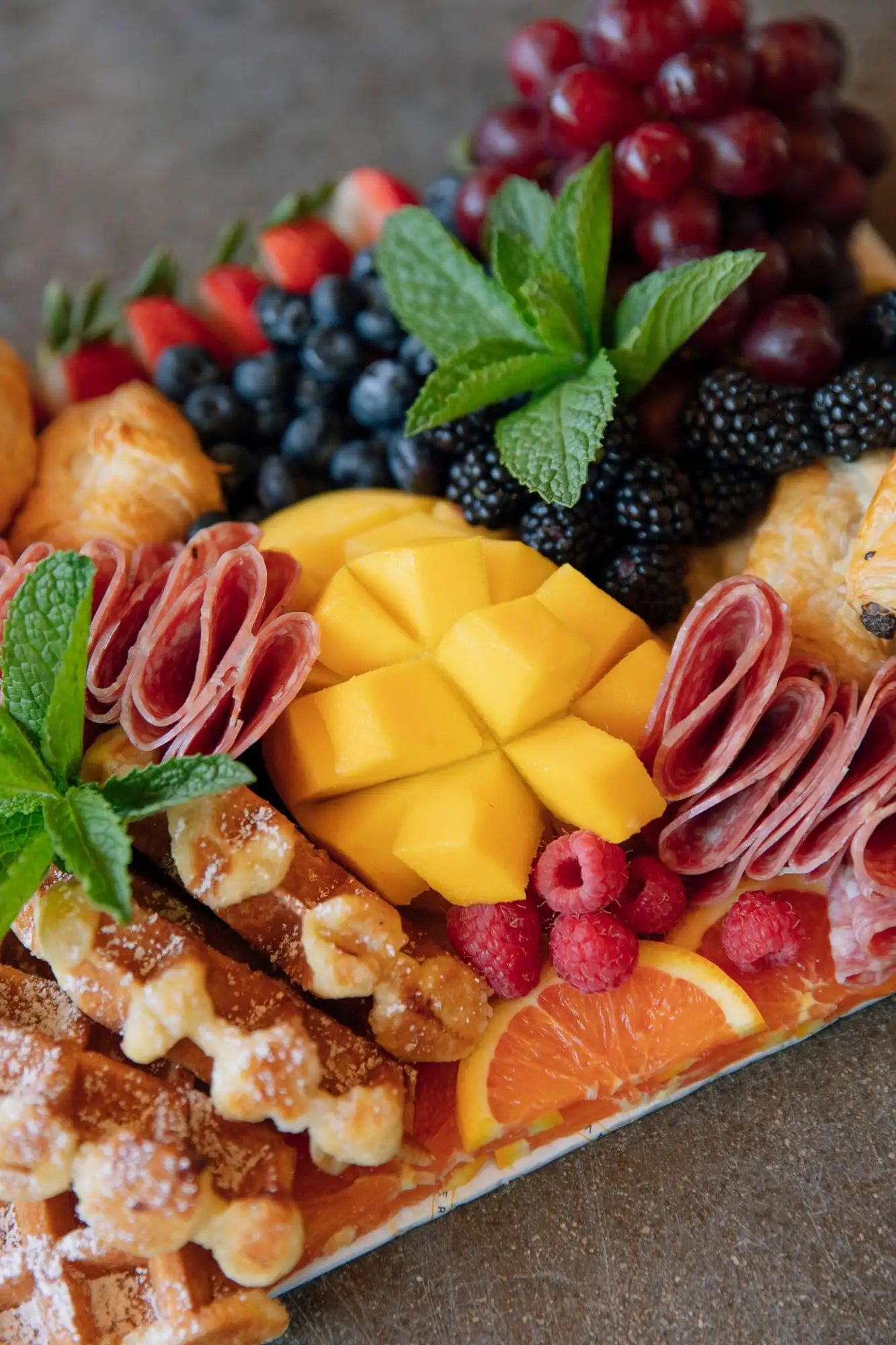 Brunch board with mini croissants, Belgian waffles, fresh fruit and salami (view 2)