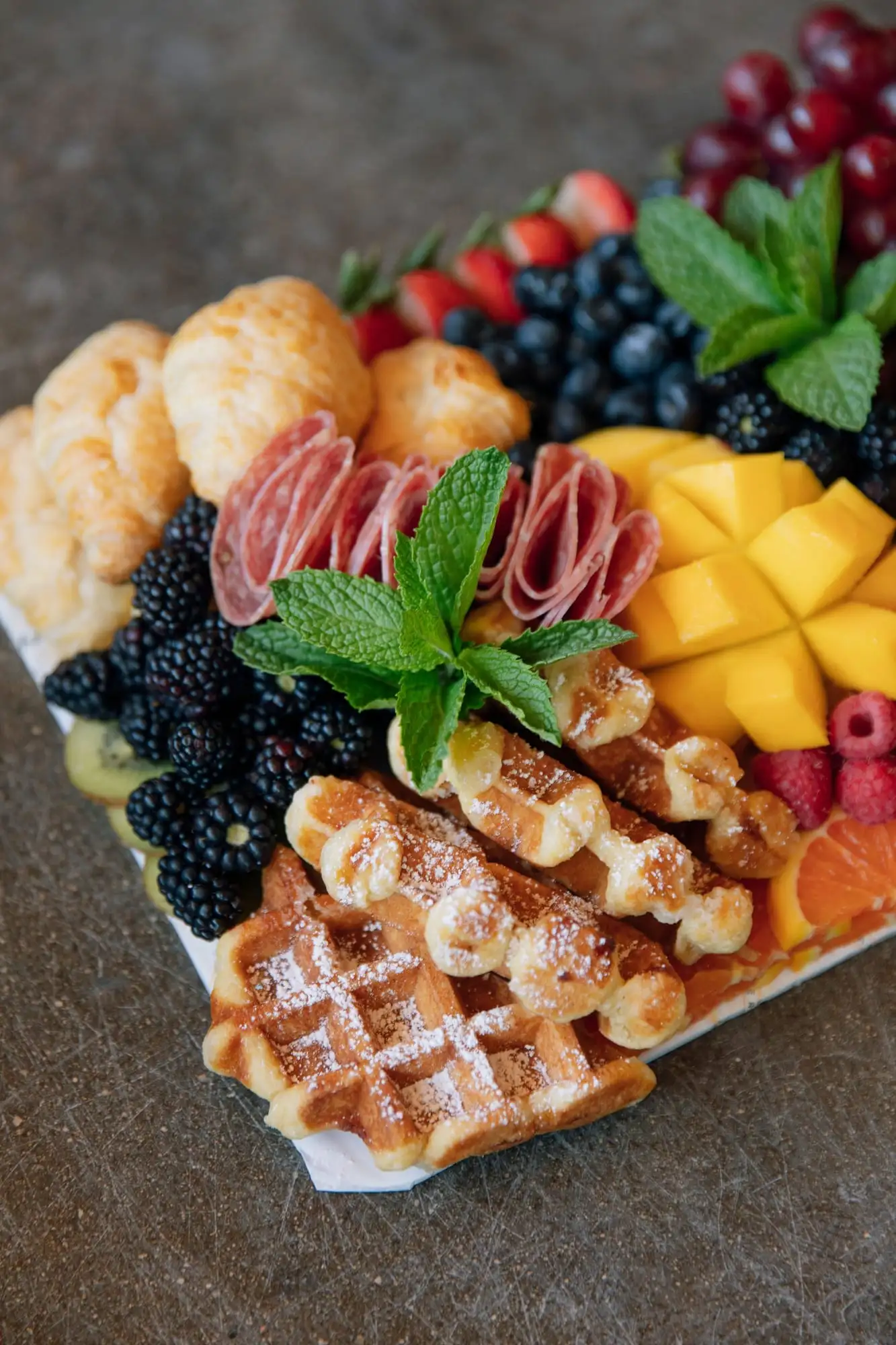 Brunch board with mini croissants, Belgian waffles, fresh fruit and salami (view 4)