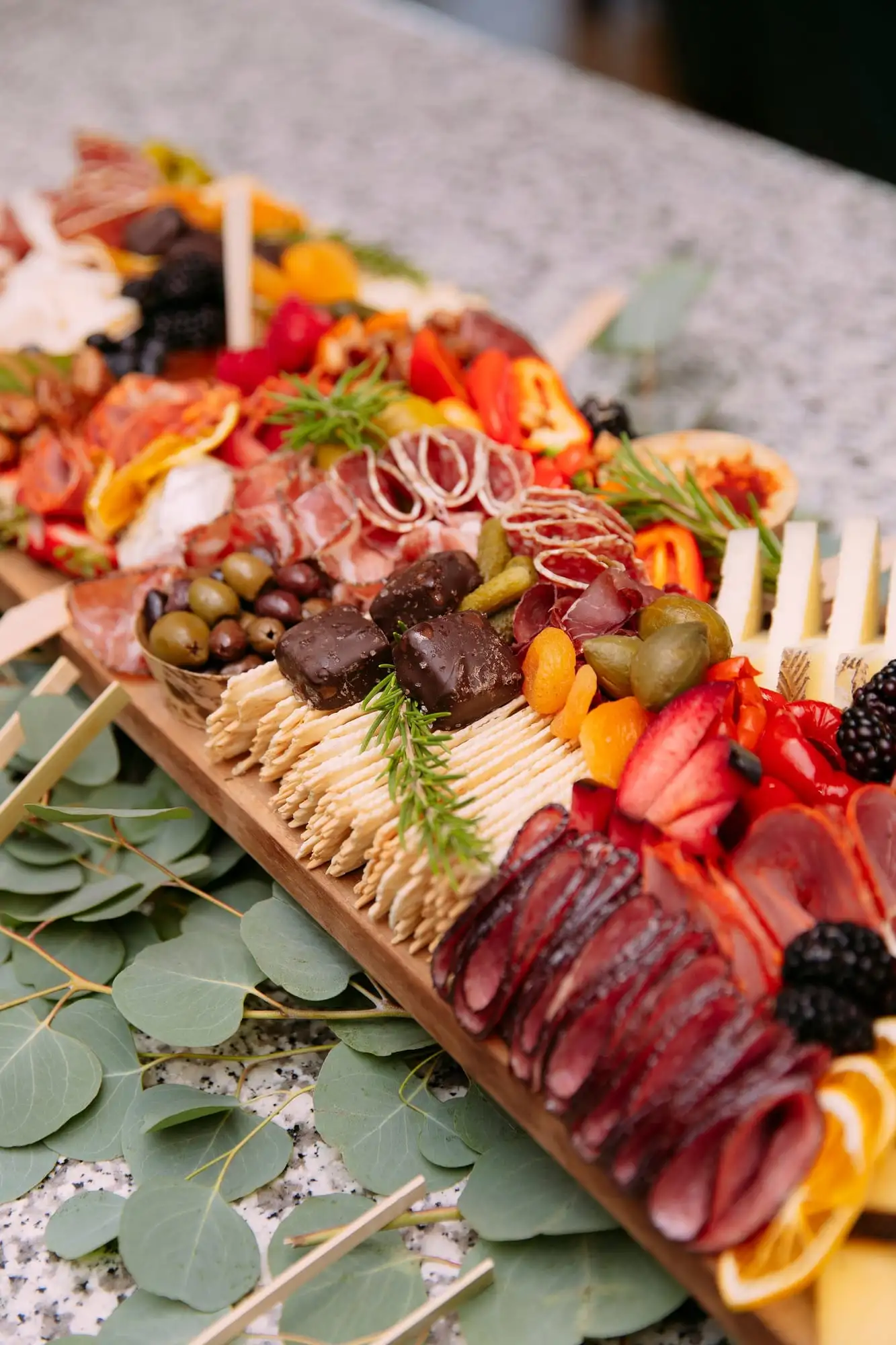 Long charcuterie board with cheeses, cured meats, fruit and chocolates for 30 guests (view 3)
