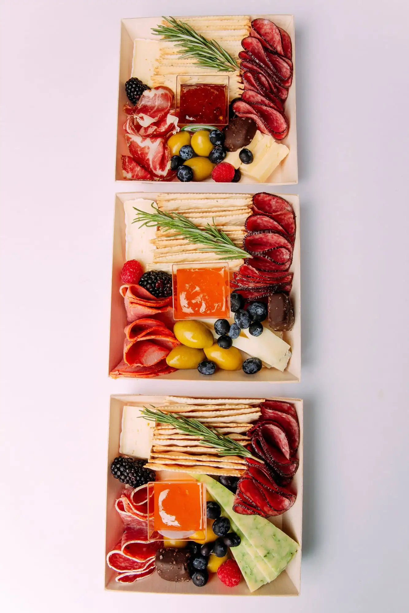 Individual charcuterie box with brie, salami, crackers, olives and fruit (view 2)