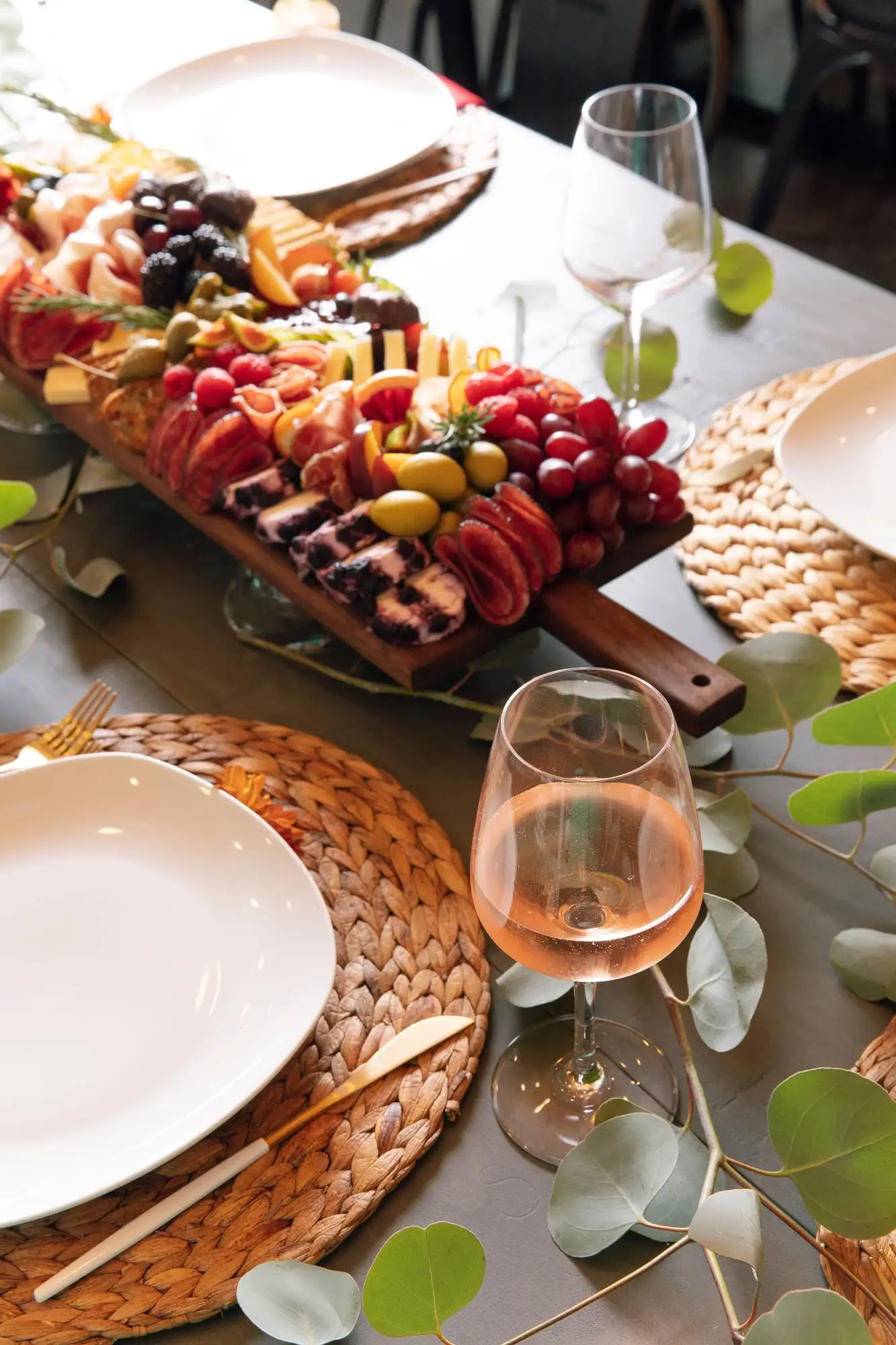 Long wooden picnic board with cheeses, charcuterie, fresh vegetables and honeycomb (view 3)