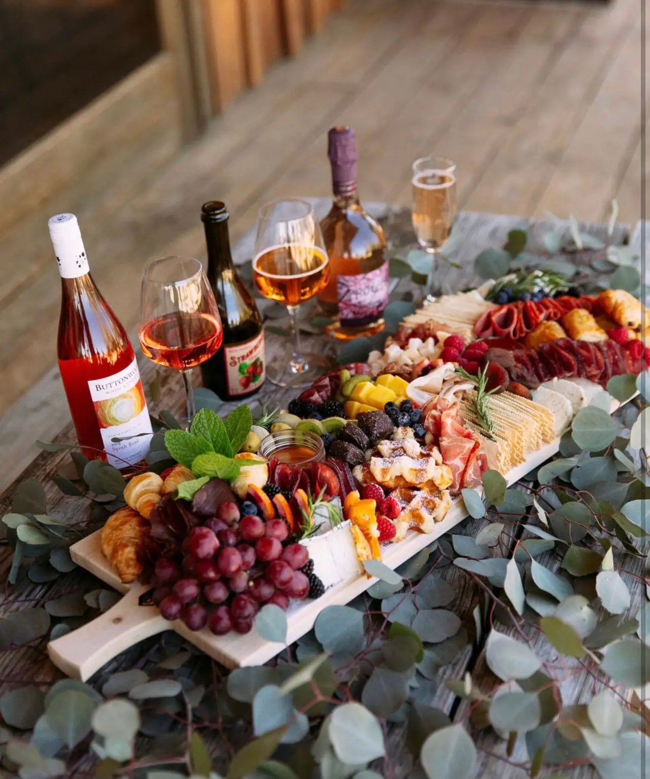 Brunch grazing board with croissants, waffles, cheeses, cured meats and fruit (view 4)