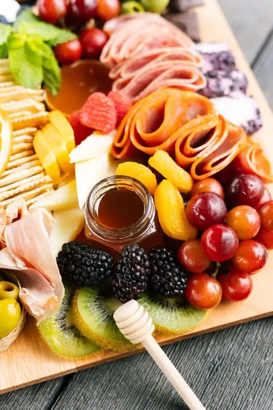Bamboo board with three cheeses, cured meats, fruit and crackers for 4 to 6 people (view 8)