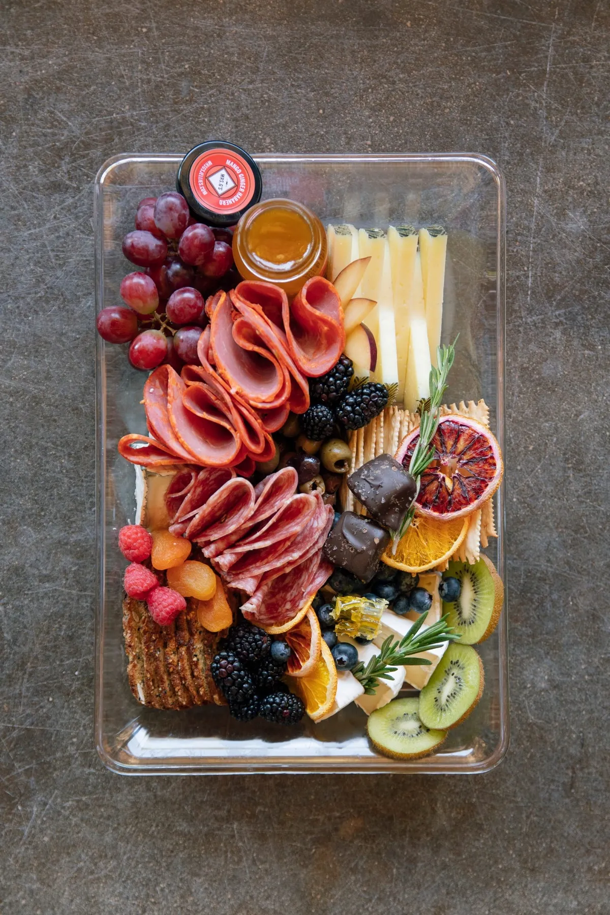 A charcuterie board in a clear container
