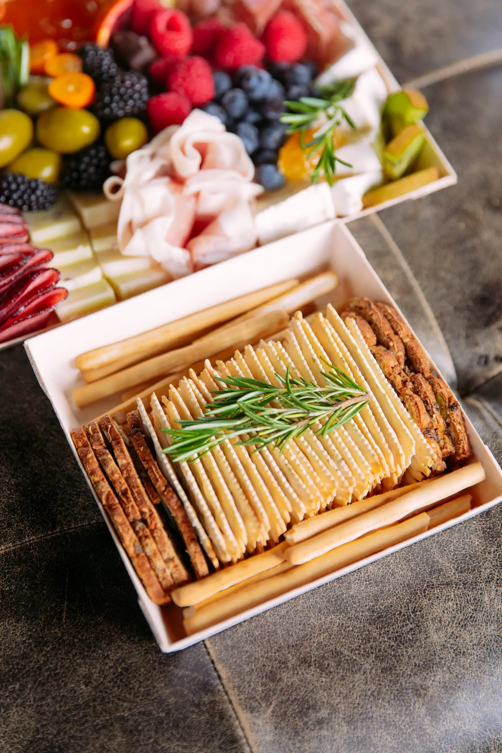 A charcuterie box with a separate box of crackers