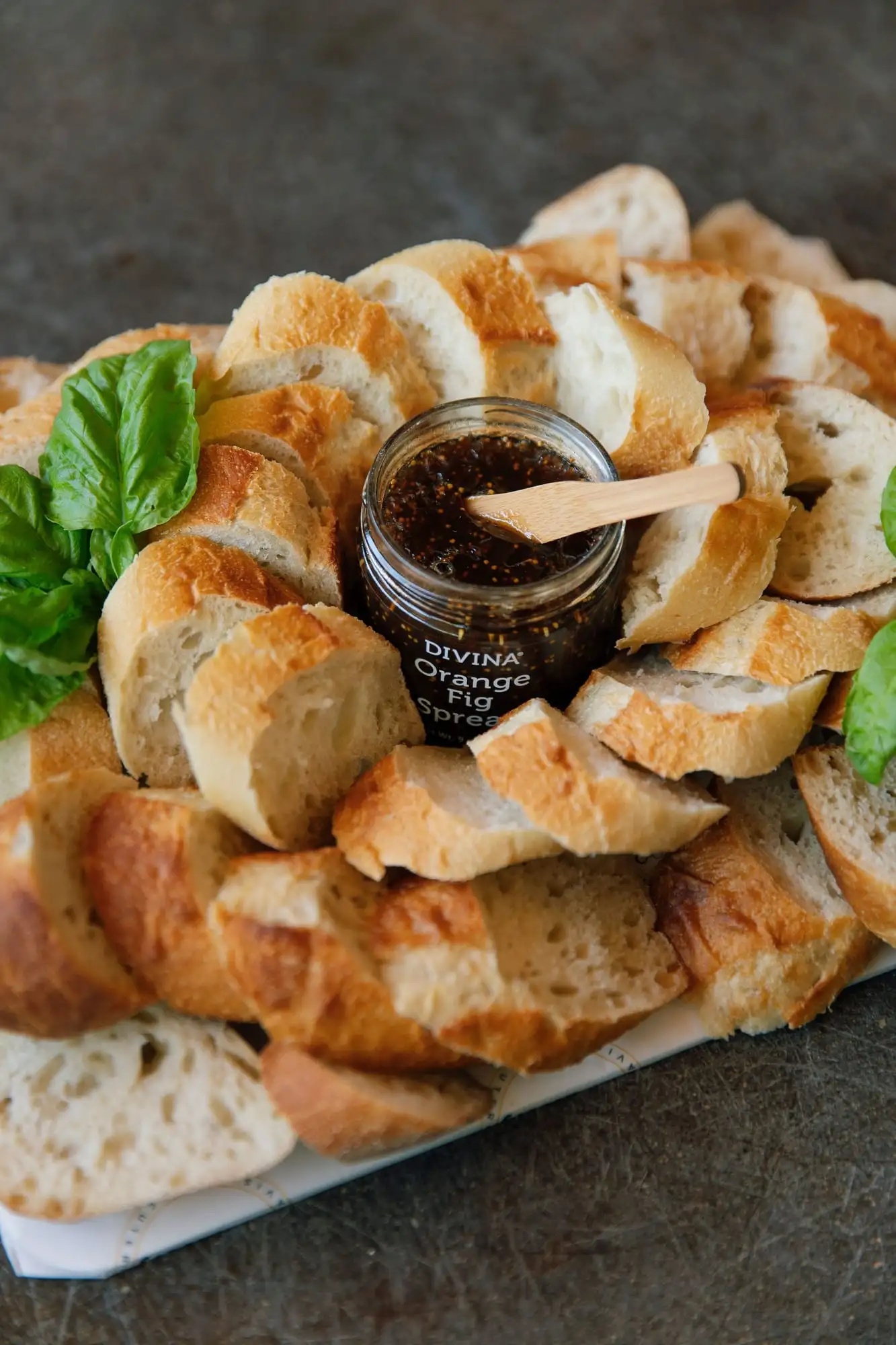 Sliced French baguette with fig spread, pepper jelly and honey