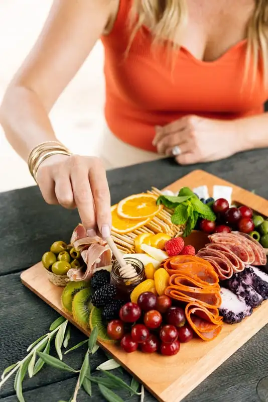 Bamboo board with three cheeses, cured meats, fruit and crackers for 4 to 6 people (view 4)