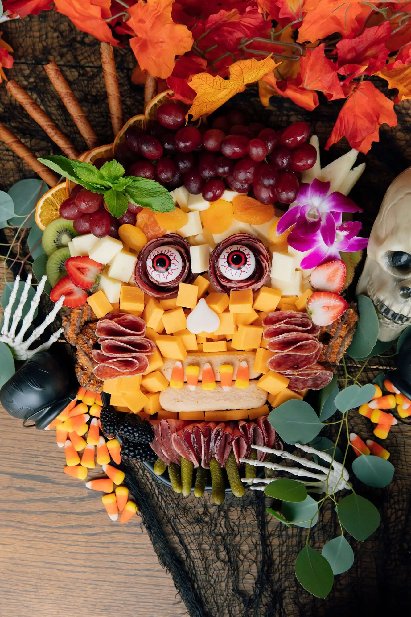 Kids Halloween charcuterie board with sweet and savory treats and candy eyeballs (view 3)