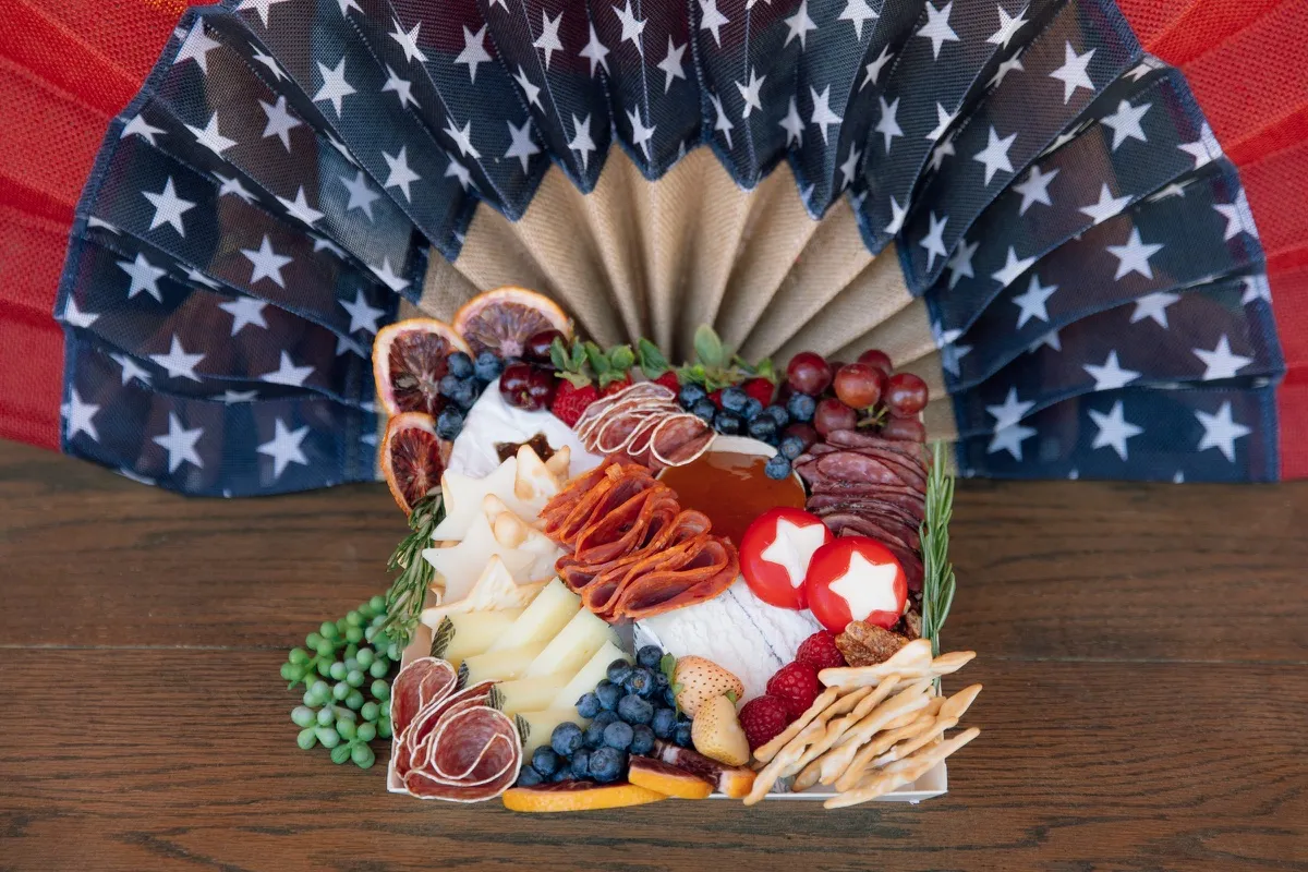 A 4th of July charcuterie board with star-shaped cheese and berries