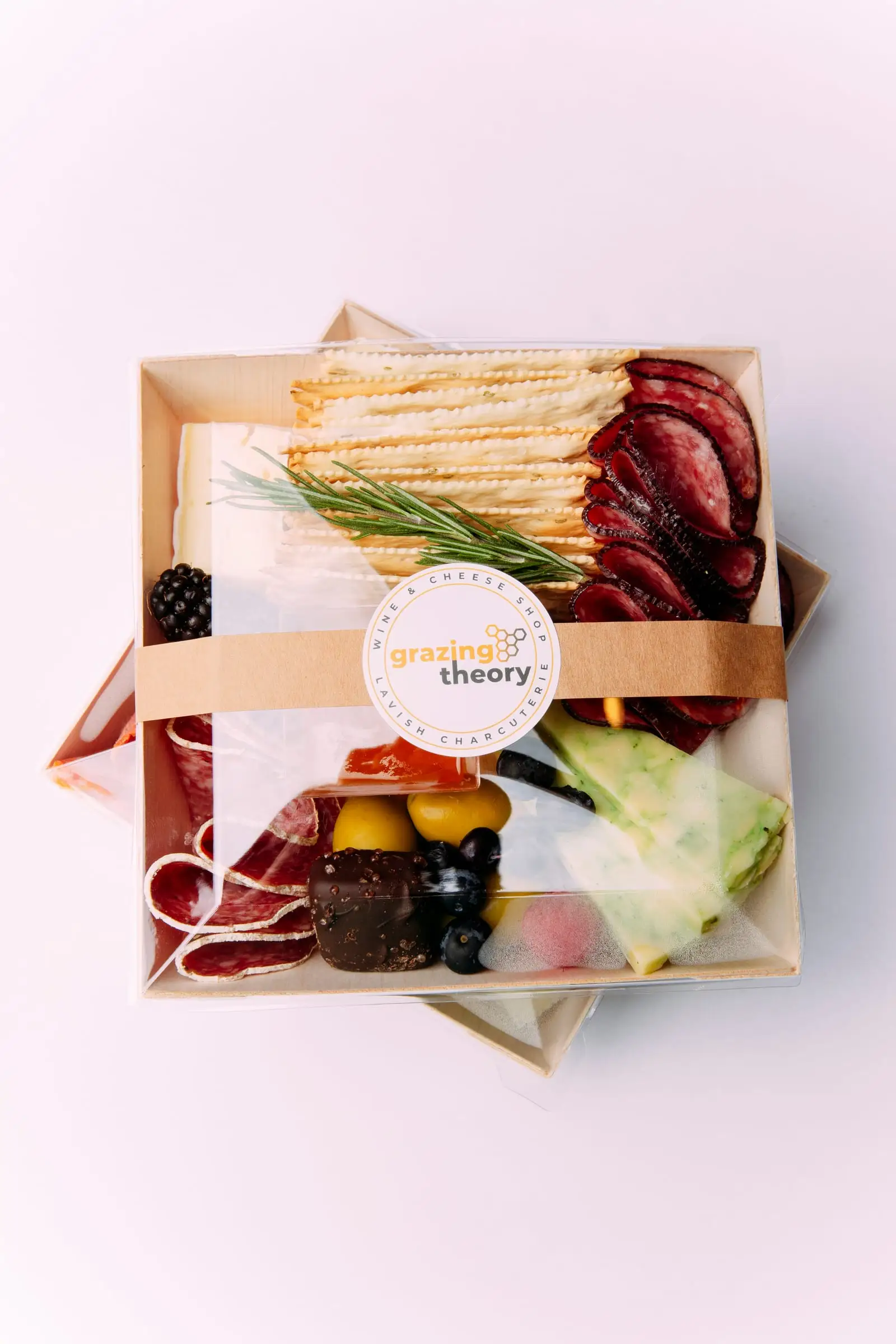 Charcuterie boxes wrapped and sealed with Grazing Theory labels